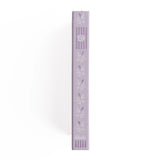 A dreamy notebook in gentle lilac vegan leather, inspired by classic library bindings. Subtle geometric embossing frames a delicate open-book motif, creating a clean, elegant design that appeals to book lovers, writers, and everyday creatives.