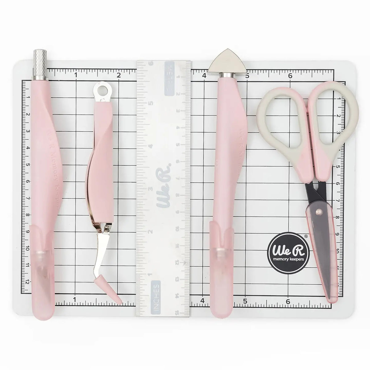 The We R Makers Mini Tool Kit in Pink is the ultimate companion for all your DIY craft projects. This comprehensive kit includes essential tools: a cutting mat, ruler, scissors, craft knife, tweezers, brad setter, and piercing tool. Designed for versatility, it's perfect for scrapbooking, journaling, card making, and a wide range of other crafts.

The vibrant pink color adds a fun and stylish touch to your toolkit, while the high-quality construction ensures each tool is durable and reliable. The cutting ma