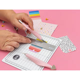The We R Makers Mini Tool Kit in Pink is the ultimate companion for all your DIY craft projects. This comprehensive kit includes essential tools: a cutting mat, ruler, scissors, craft knife, tweezers, brad setter, and piercing tool. Designed for versatility, it's perfect for scrapbooking, journaling, card making, and a wide range of other crafts.

The vibrant pink color adds a fun and stylish touch to your toolkit, while the high-quality construction ensures each tool is durable and reliable. The cutting ma