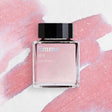 A tender rose quartze hue is veiled with graceful bluish tones, where silver and sapphire shimmer cast a cool, delicate sparkle across the surface, reflecting Emma's innocence and immaturity in how she so easily judged love.