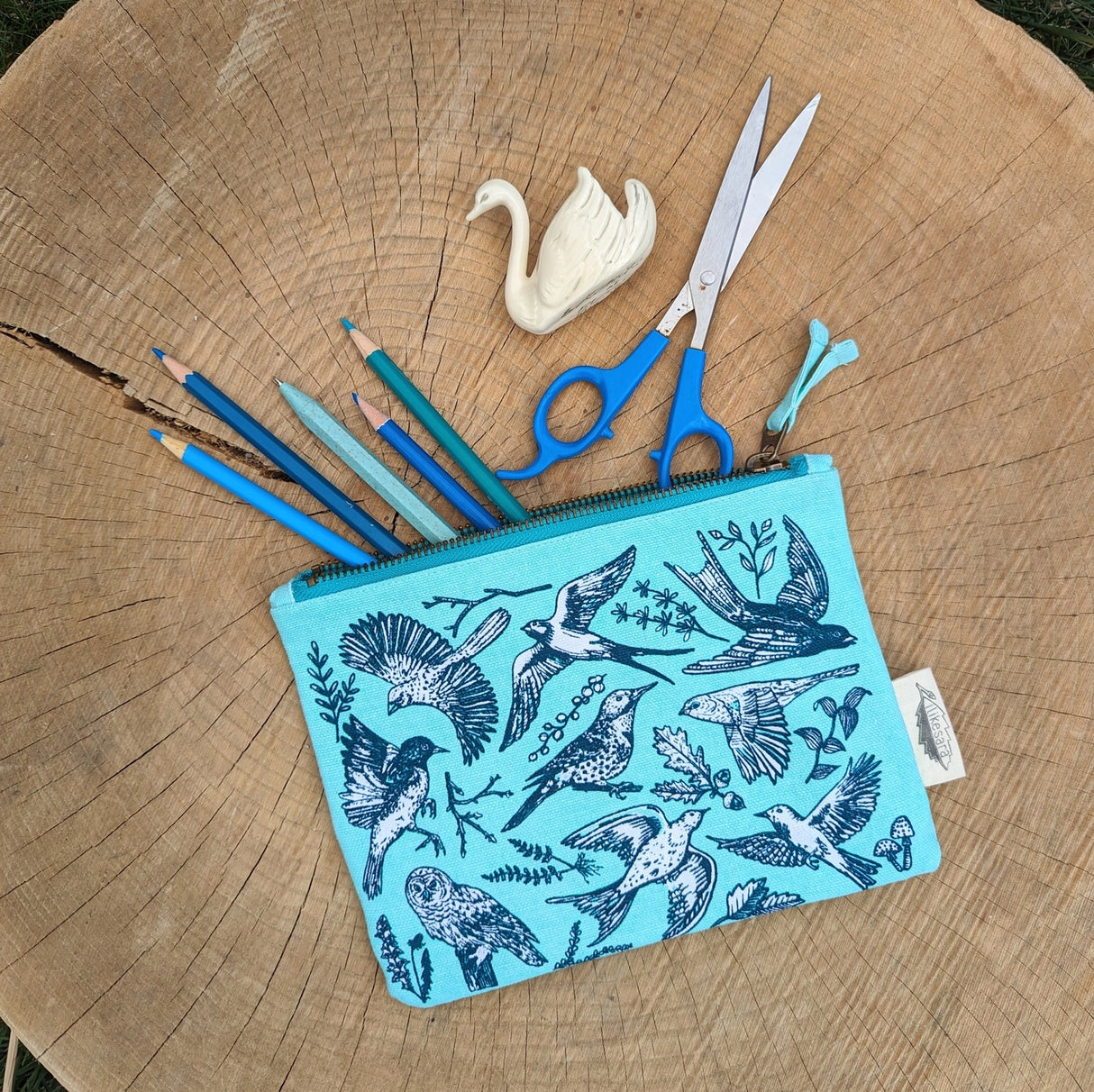 Take some feathered friends everywhere you go with this canvas bird zippered pouch. Featuring bird illustrations by ilikesara (aka Sara Schalliol-Hodge) combined with botanicals, this handy zippered pouch will keep you organized (in flight or on land!). Great for storing snacks, pencils, bird seed, your feather collection, etc. The water-resistant inner layer is not only wipeable but adds structure to the bag.