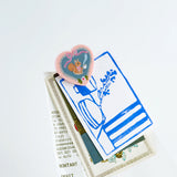 Hobonichi 2027 - Yumi Kitagishi: Clips (Set of 3)

This clip can be fastened to the edge of your techo to act as a bookmark or&nbsp;used to hold a stack of papers together. This&nbsp;features illustrations of three types of animals drawn by Yumi&nbsp;Kitagishi. This set of three clips features the familiar White Cat,&nbsp;along with a squirrel and a white dog. Made of acrylic resin, they&nbsp;have a strong presence and will brightly decorate your techo.